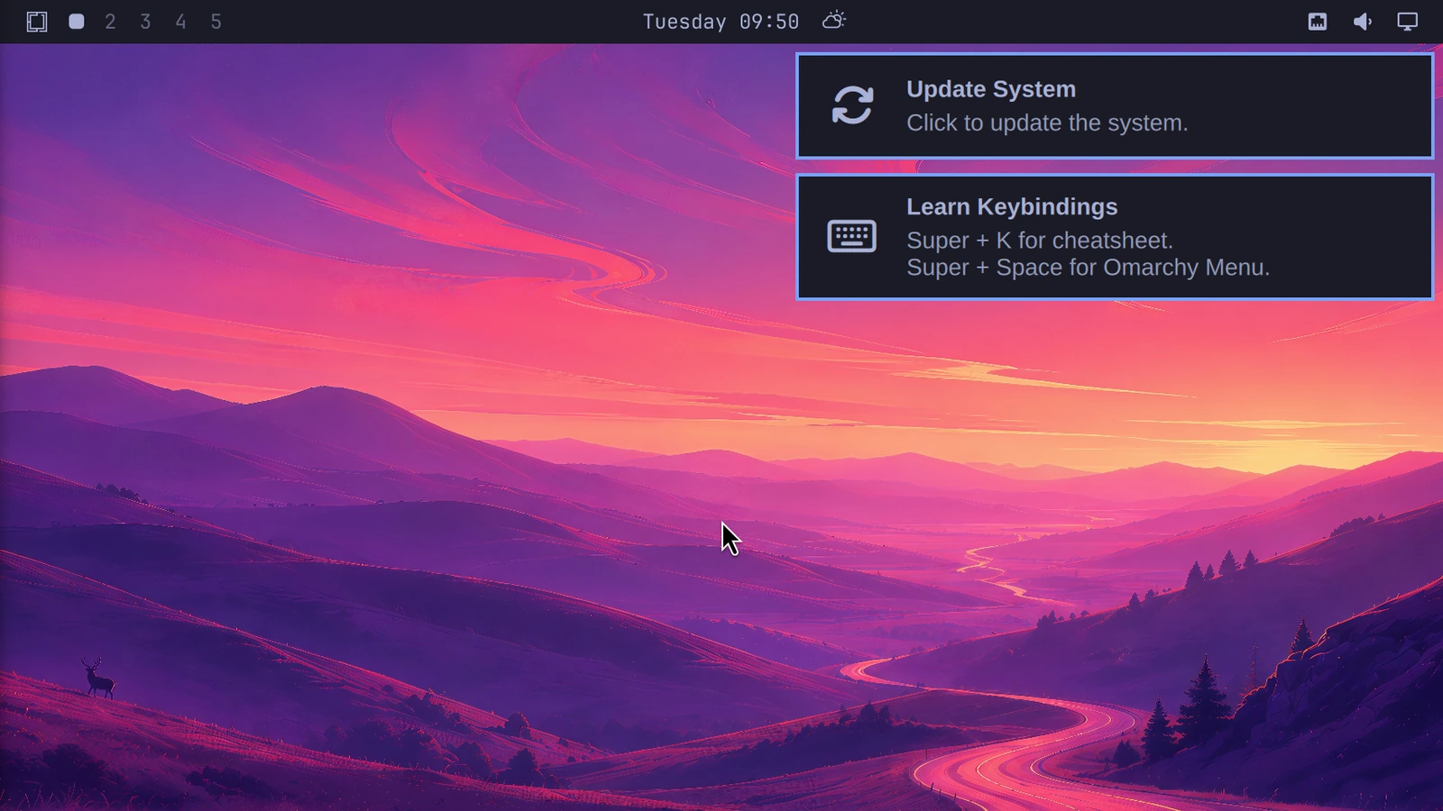 Omarchy desktop with its wallpaper, top bar, and shell UI visible after a guest OS reboot.